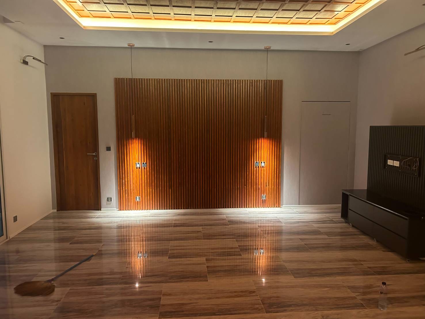 Living room with custom wood slat feature wall and integrated lighting