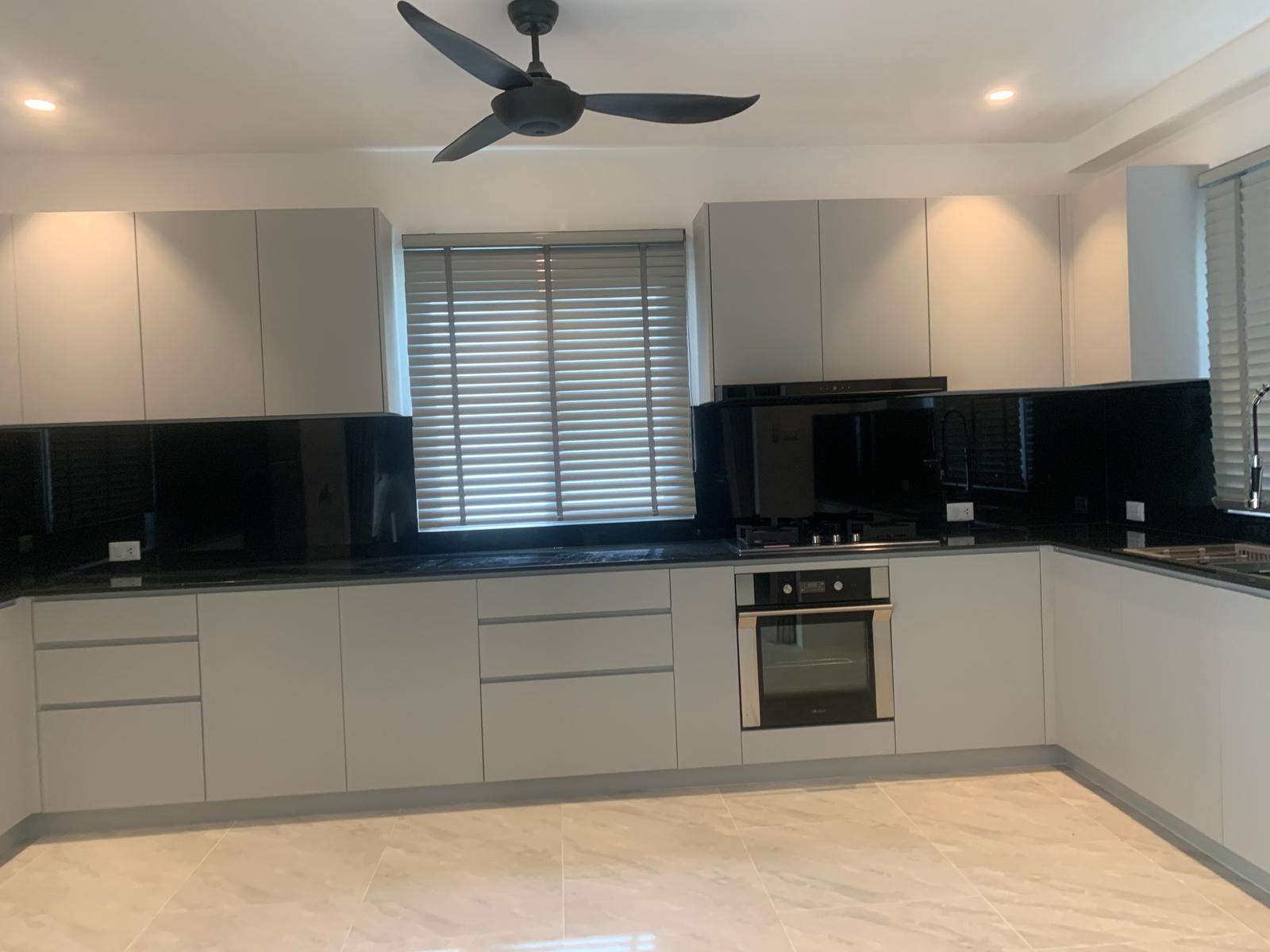 Traditional U-shaped kitchen with white cabinets and dark granite countertops